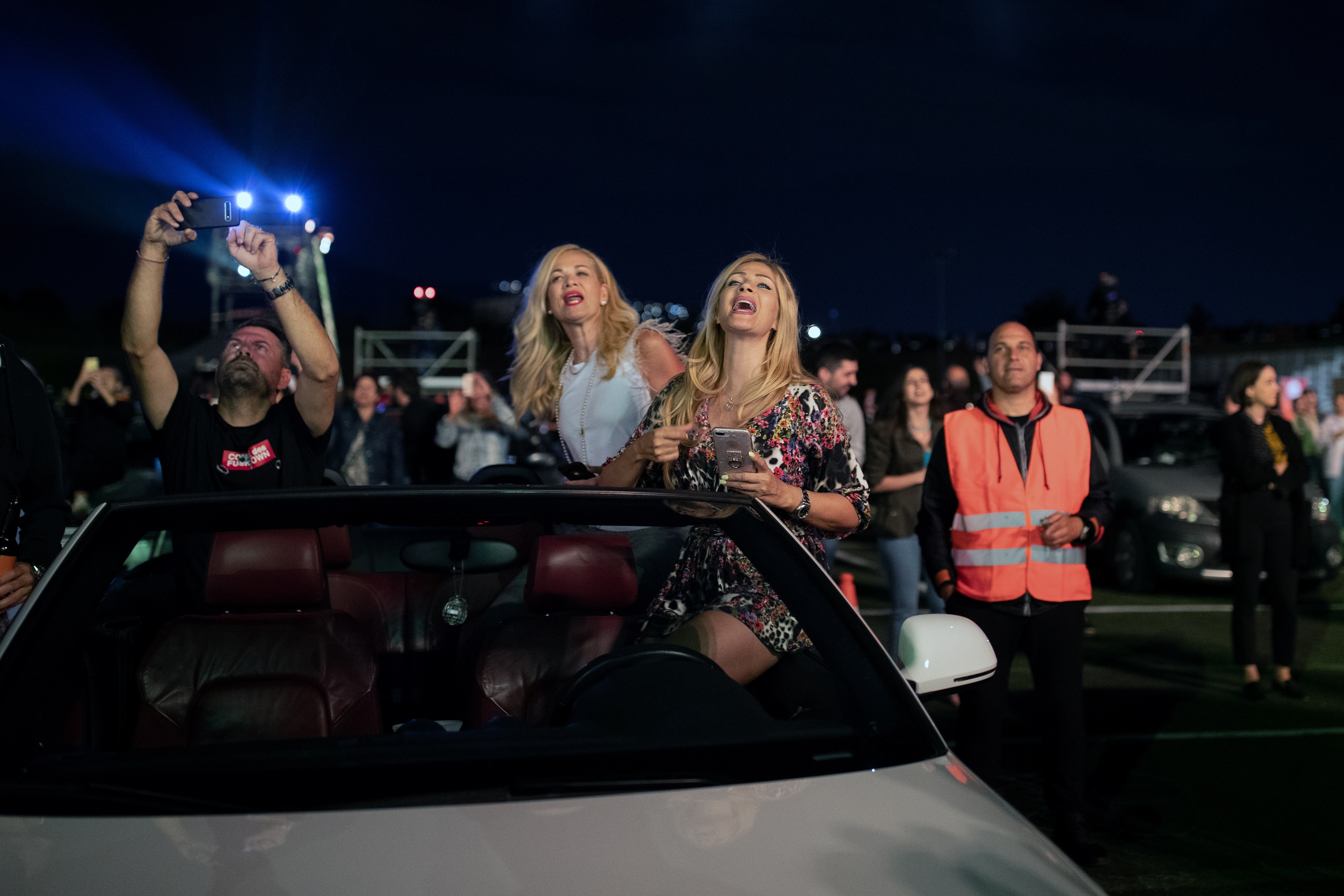 File photo: People emerge from sunroofs to sing during a drive-in concert of popular Greek singer Natassa Theodoridou.