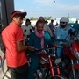 Commuters at a fuel station in Peshawar.  (AFP)