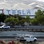 FILE PHOTO: Motorists drive past Tesla's primary vehicle factory after CEO Elon Musk announced he was defying local officials' restrictions against the spread of the coronavirus disease (COVID-19) by reopening the plant in Fremont, California, U.S. May 12, 2020. REUTERS/Stephen Lam/File Photo (REUTERS)