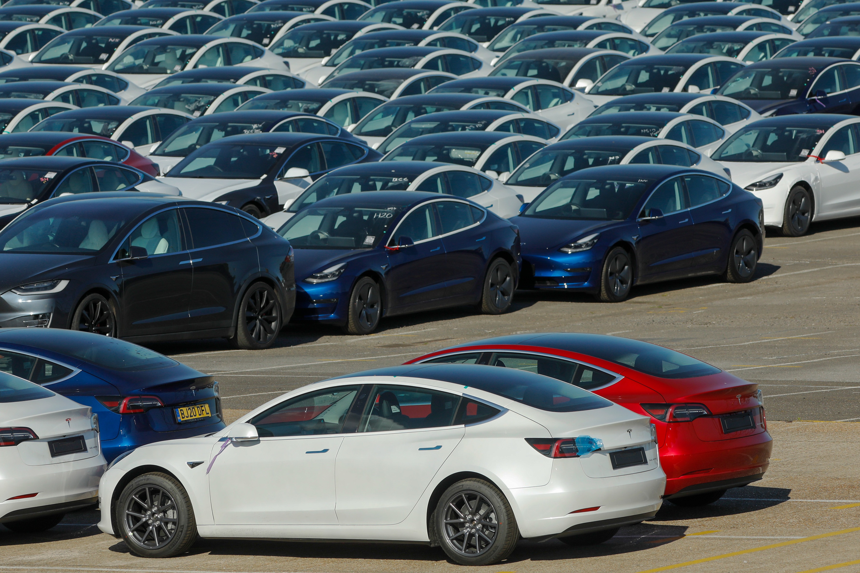 In addition to buoying Tesla, the energy office’s earliest loans and loan guarantees also had a role in establishing America’s first large-scale solar-power plants. (File photo of Tesla EVs)