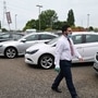 A car sales person wearing PPE (personal protective equipment) including a face mask and gloves as a precautionary measure against COVID-19, (Photo by JUSTIN TALLIS) (Representational File Photo) (AFP)
