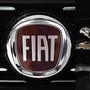 This combination of file pictures created on October 31, 2019 shows the logo of Italian auto maker Fiat (L) in a cars dealer on January 12, 2017 in Saluzzo, near Turin, and the Peugeot logo pictured at the 2014 Paris Auto Show on October 3, 2014 in Paris. (AFP)