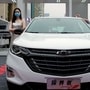 File photo: A model wearing a face mask following the coronavirus disease (Covid-19) outbreak stands next to a Chevrolet vehicle at a sales event in China. (REUTERS)
