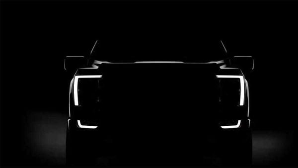 Ford Motor has teased a silhouette image of the new 2021 F-150 pickup truck with the newly designed headlights turned on.