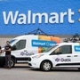 Gautam Narang, CEO and co-founder of self-driving startup Gatik, seen with his fleet in front of a Walmart store. (Photo courtesy: Gatik)