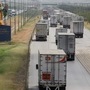 Trucks wait in a long queue for border customs control to cross into the US, at the World Trade Bridge in Nuevo Laredo, Mexico June 30, 2020.  (REUTERS)