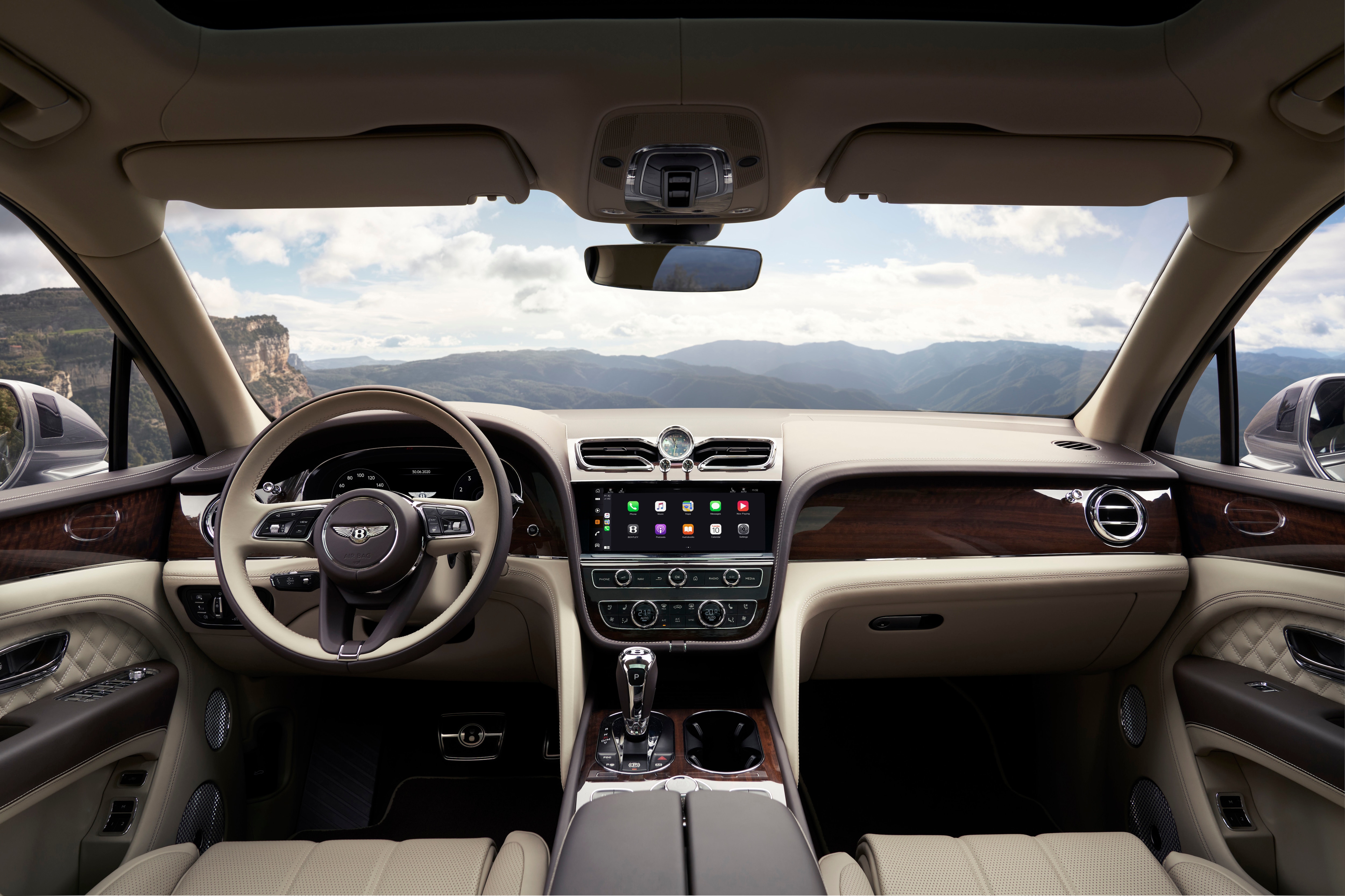 A new infotainment system with a 10.9-inch display screen sits on the the handcrafted Bentley dashboard design.