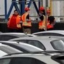Tesla workers in orange vests are seen outside the company's California plant. (REUTERS)