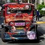Passengers wearing masks for protection against the coronavirus disease wait for a jeepney with plastic barriers inside to maintain social distancing. (REUTERS)
