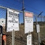 File photo - Signs warning of the presence of oil pipelines are seen on a fence  outside facilities run by Enbridge, Kinder Morgan and Suncor in Sherwood Park near Edmonton, Alberta, Canada. (REUTERS)