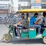 Passengers travel in an e-rickshaw.