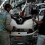 FILE PHOTO: Employees, wearing protective face masks, work on the automobile assembly line of Renault ZOE cars at the Renault automobile factory in Flins. (REUTERS)