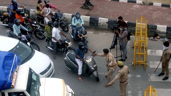 Police personnel stop commuters at Delhi Noida Border after it was sealed during the two day lockdown imposed by the state government to curb the spread of coronavirus. (File photo)