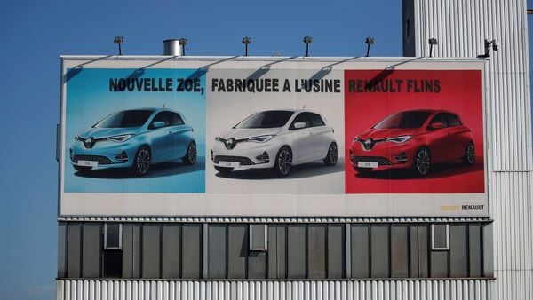 A placard showing Renault Zoe cars is seen at the Flins plant of French carmaker Renault in Aubergenville, west of Paris. (REUTERS)