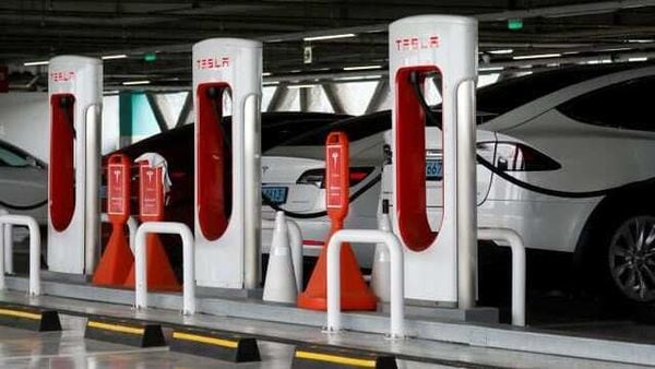 Tesla electric vehicles are charged at a Tesla Supercharger charging station. (File photo)