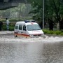 An ambulance wades through a waterlogged road after heavy rains in Noida. (PTI)