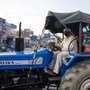 A man wears a protective mask while driving a tractor in Gharaunda, Haryana, India on Friday, June 26, 2020. From March through May, around 10 million migrant workers fled India�s megacities, afraid to be unemployed, hungry and far from family during the world�s biggest anti-Covid lockdown. Migrant workers aren�t expected to return to the cities as long as the virus is spreading and work is uncertain. Photographer: Prashanth Vishwanathan/Bloomberg (Bloomberg)