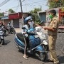 A police constable stops commuters from entering a restricted red zone area at Talab Tillo, in Jammu. (File photo) (PTI)