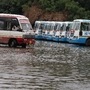 Vehicles passing through the waterlogging Gurugram bus stand after the rains at the bus stand.
