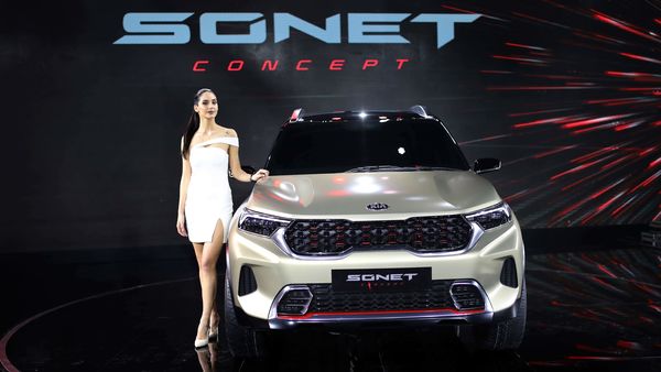 A model poses next to KIA Sonet Concept car at the Auto Expo in Greater Noida. (AP)