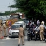 Police personnel check ID cards of commuters at Delhi Noida Border. (file photo)