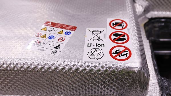 A recycling symbol sits on a lithium-ion battery pack of a Volkswagen e-Golf electric automobile. (Bloomberg)