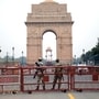 Police personnel stand guard outside India Gate ahead of Independence Day celebrations, in New Delhi.