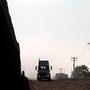 A truck rides along the Mexico-US border fence before lining up to cross to the US at the Otay commercial port of entry in Tijuana, Baja California state, Mexico.