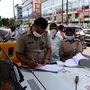 Police personnel fine a motorist in Noida. (File Photo)