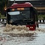 File photo - DTC bus makes his way through a flooded street during heavy rainfall, in New Delhi.