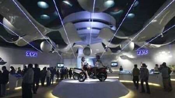 Visitors walk at TVS motorcycle pavilion at an auto expo in New Delhi January 6, 2010. (File photo)