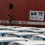 FILE PHOTO:  A worker climbs a container to close its window after unloading cars at a warehouse on the outskirts of Ahmedabad February 11, 2013. REUTERS/Amit Dave/File photo (REUTERS)