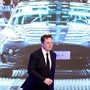 FILE PHOTO: Tesla Inc CEO Elon Musk walks next to a screen showing an image of Tesla Model 3 car. (REUTERS)