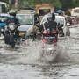 Vehicles move on a waterlogged street followed heavy rain, at Wadala in Mumbai, Wednesday, Sept. 23, 2020. (PTI)