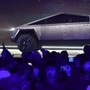 In this file photo taken on November 21, 2019 people take pictures of the newly unveiled all-electric battery-powered Tesla's Cybertruck at Tesla Design Center in Hawthorne, California. (AFP)