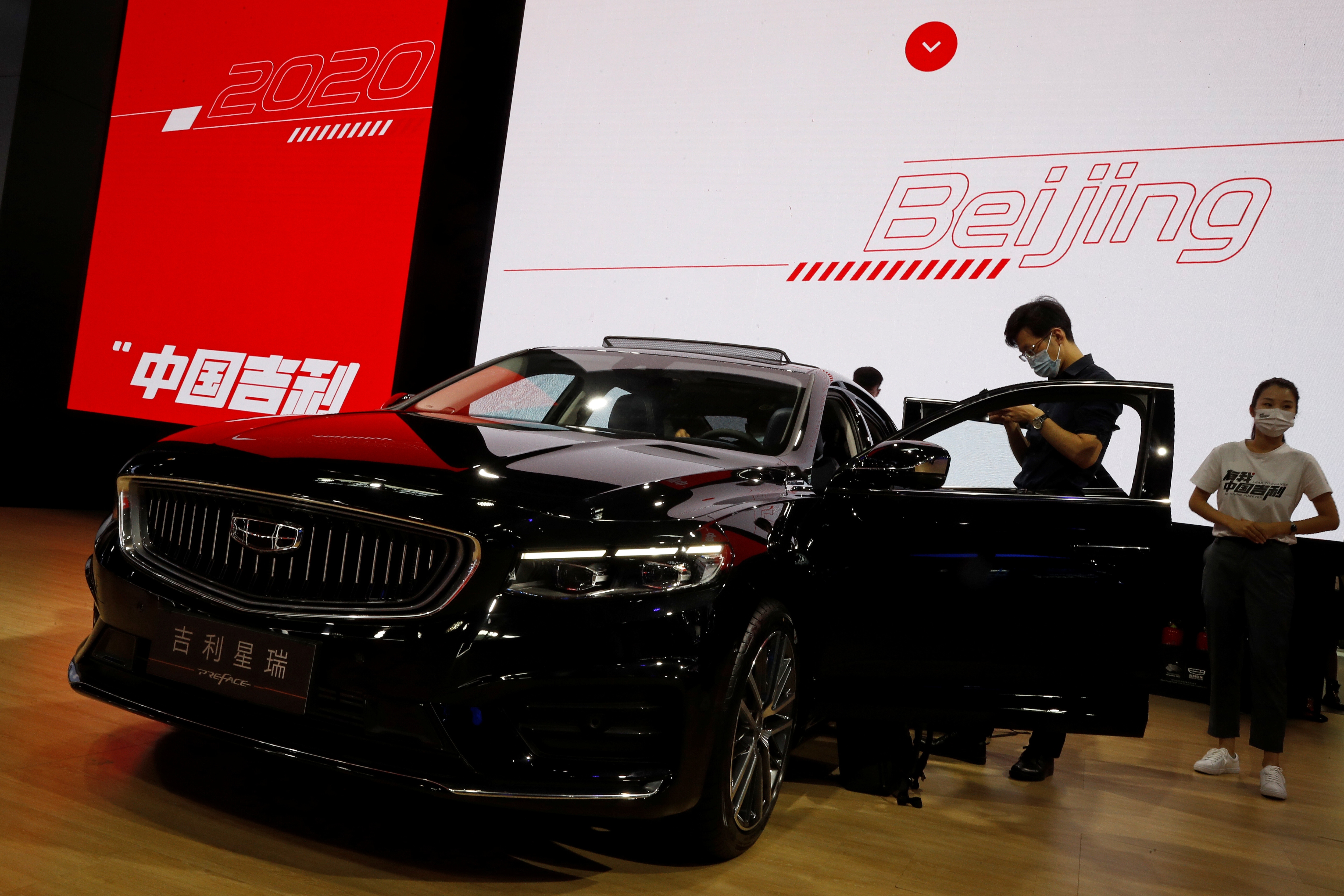 In pics Masked fans throng halls as Beijing Auto Show gets underway