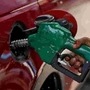 A worker holds a nozzle to pump petrol into a vehicle at a fuel station in Mumbai. (File photo) (REUTERS)
