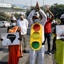 Aam Aadmi Party party workers hold placards as they urge people to turn off the engines of their vehicles while waiting at traffic signals, during a campaign launched by Delhi Chief Minister Arvind Kejriwal.