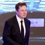 Tesla Inc CEO Elon Musk walks next to a screen showing an image of Tesla Model 3 car during a ceremony. (File Photo) (REUTERS)