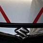 The logo of Maruti Suzuki India Limited is seen on car parked outside a showroom in New Delhi. (File Photo) (REUTERS)