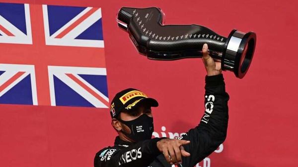 Mercedes F1 racer Lewis Hamilton celebrates on the podium. (Pool via Reuters)