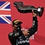 Mercedes F1 racer Lewis Hamilton celebrates on the podium. (Pool via Reuters)