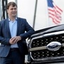 File photo - Ford Motor Co. CEO Jim Farley poses next to a new 2021 Ford F-150 pickup truck at the Rouge Complex in Dearborn, Michigan. (REUTERS)