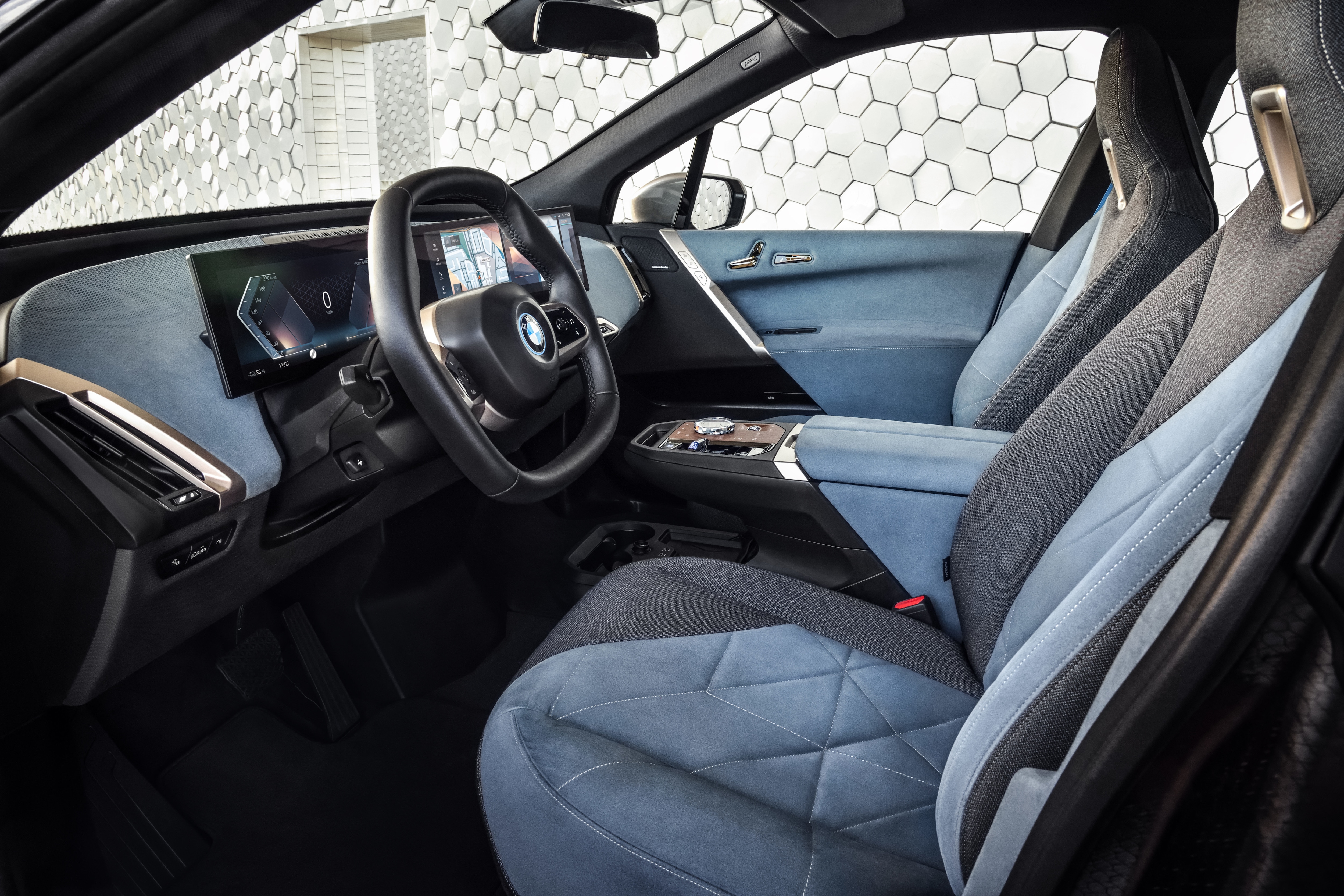 Inside the cabin, the BMW iX electric SUV will feature a dashboard with a sweeping, curved screen. 