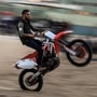 A young Palestinian rides his motorcycle on a sandy hill during a weekly show in the Al-Zahra area, near Gaza City. (AFP)