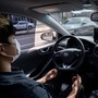 A photo taken on May 28, 2020 shows a safety driver sitting behind the wheel of a Rideflux 'self-driving' car in Jeju. - In a workshop that blends a corporate office with a tool-packed garage, South Korean company Rideflux are looking to take on the multi-billion-dollar giants of Uber, Tesla and Google parent Alphabet with a self-driving car of their own. Their modified Hyundai Ioniq, festooned with cameras and proximity sensors, is the first autonomous vehicle to go into regular service on public roads in the country. (Photo by Ed JONES / AFP) / TO GO WITH:  SKorea-automobile-transport-technology, FOCUS by Kang Jin-kyu (AFP)