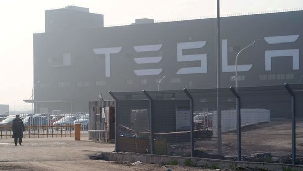 FILE PHOTO: A Tesla sign is seen on the Shanghai Gigafactory of the U.S. electric car maker before a delivery ceremony in Shanghai, China December 30, 2019. REUTERS/Yilei Sun/File Photo (REUTERS)