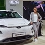 A model poses next to a Hyundai Kona Electric car displayed at the Auto Expo 2020 in Greater Noida. (File photo) (PTI)