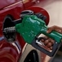 A worker holds a nozzle to pump petrol into a vehicle at a fuel station in Mumbai. (Representational photo) (REUTERS)