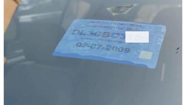 Colour coded sticker on the front windshield. The blue in this image denotes this is a petrol vehicle.